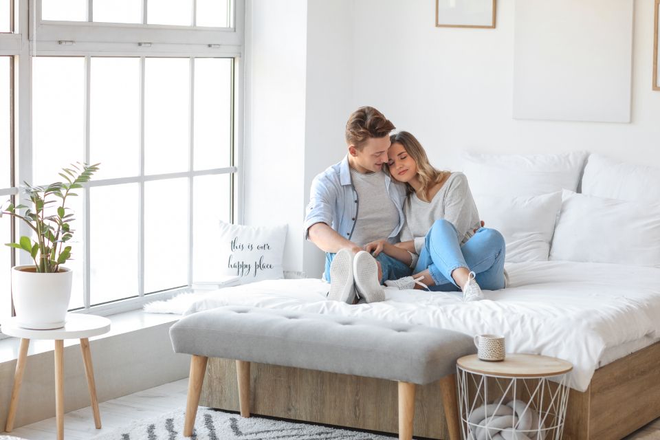 A guest room with a large bed and soft lighting