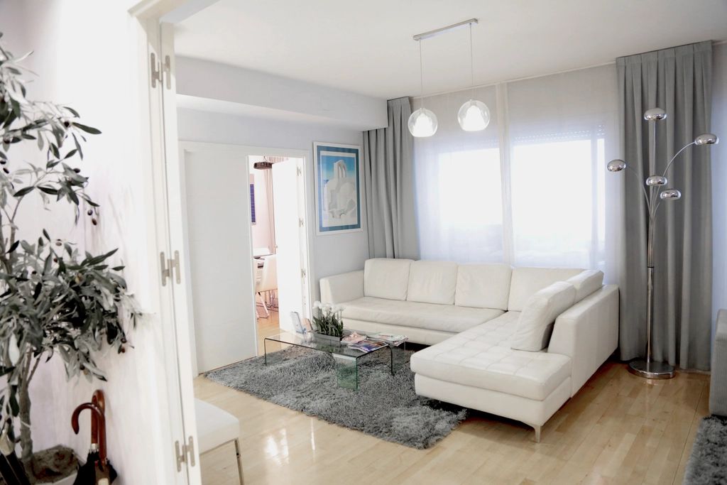 A suite sitting room with a sofa and armchairs